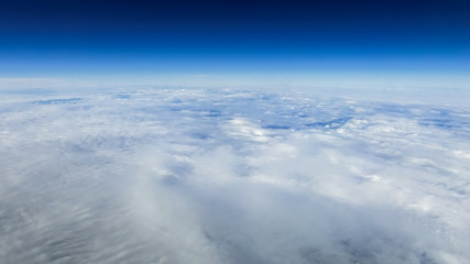 Obraz premium The beautiful cloudscape with clear blue sky. A view from airplane window.