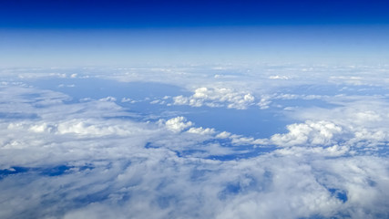 Wonderful view of cloudscape with clear blue sky from above.