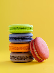 colorful macaroons isolated on yellow background. sweet biscuit. Traditional cake