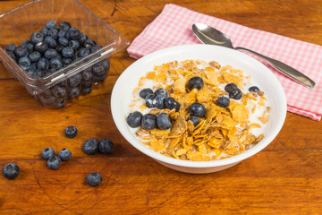 Bowl of Cereal with Blueberries on Rustic Wood Table