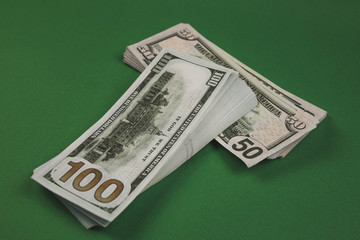 Dollars bundle, rubles and euros on green background. Cash stacks of different size. Earned with hard labor. Money savings on old table.