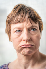 Fototapeta premium Paris, France - 05 19 2019: Studio photo session with my girlfriend. Woman with bad expressive face