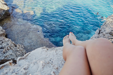 Female legs close up relaxing on the beach. Vacation holidays