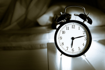 Alarm clock - vintage  classic alarm clock next to bed in bedroom