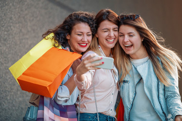 Three beautiful girls with shopping bags