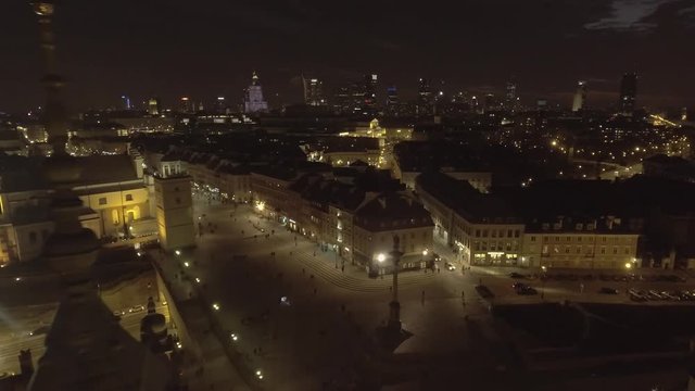 Aerial view of the cityscape of the old city at night. Warsaw Poland. Top view of the royal palace and rooftops old buildings. Taken from the drone in RAW Format. 4K.