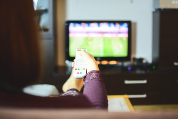 Happy woman or football fan watching soccer on tv and celebrating victory at home. Friendship, sports and entertainment concept