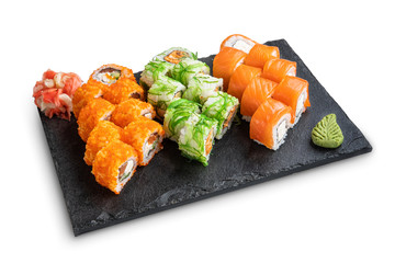 Set of rolls with wasabi and pickled ginger on stone serving board