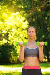 Young slim fitness woman doing fitness activity