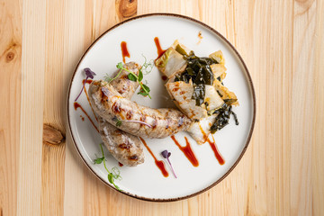 Fried Weisswurst (white veal sausage) with marinated cabbage and sea wed