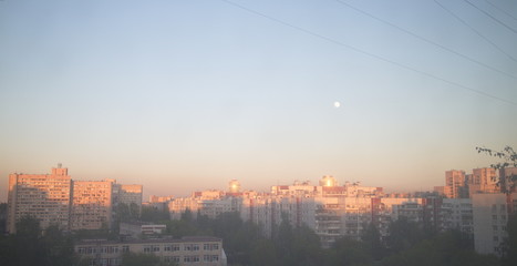 Fototapeta premium the sun rises over the city quarter