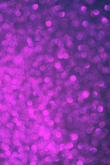 Blurred bokeh dark violet purple and black background, Christmas and New Year party holidays concept. Festive holiday card bright backdrop. Defocused. Flat lay, top view, copy space.