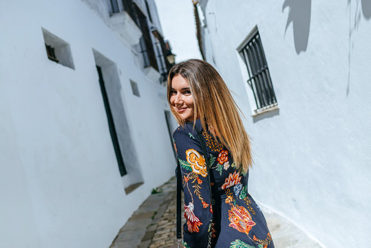 Spain, Cadiz, Vejer de la Frontera, portrait of fashionable woman wearing dress with floral design