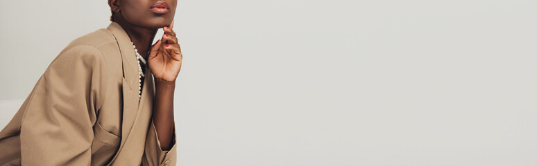 cropped view of fashionable african american woman in beige jacket isolated on grey