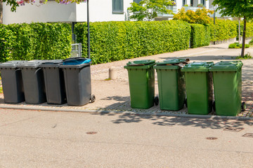 Garbage cans at the sun flooded street