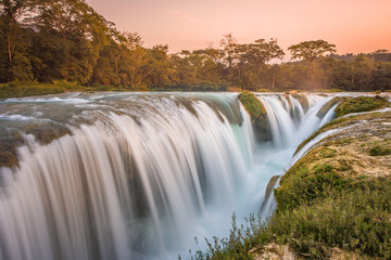 Amazing sunset over the turquoise waterfalls at Las Nubes in Chiapas, Mexico