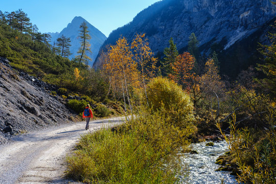 Austria, Tyrol, Karwendel mountains, Hinterautal, woman hiking along River Isar