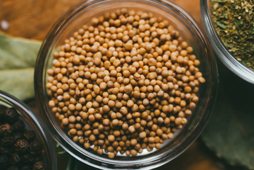 Round glass bowl with spice  - mustard seeds.