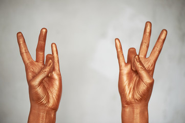 Hands in gold paint, the hands of the artist and creative person. Yoga for hands