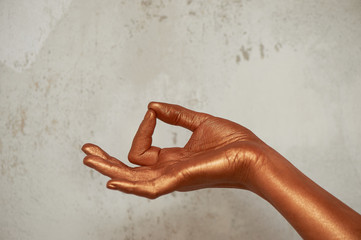 Hands in gold paint, the hands of the artist and creative person. Yoga for hands