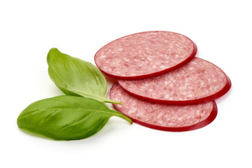 Sliced Salami, smoked sausage with basil, close-up, isolated on white background