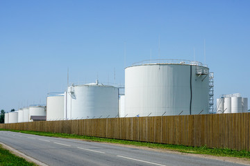 white cylindrical storage tanks for petroleum products
