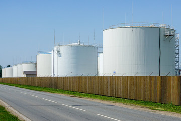 white cylindrical storage tanks for petroleum products