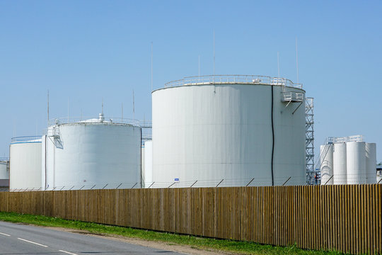 white cylindrical storage tanks for petroleum products