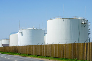 white cylindrical storage tanks for petroleum products