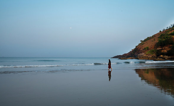 Monk  walking  along sea. South India. Morning. 
