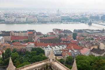 Obraz premium Budapest, Hungary. View of the city in cloudy weather from the tower of the Cathedral of St. Matthias. Danube River. Spring. Tourism and travel. Skyview. Top view.