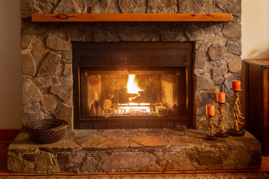 Fire in a cozy mountain cabin in the fireplace on a romantic night.