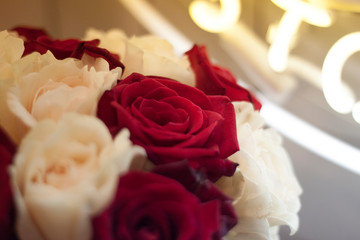 wedding rings on a bouquet of red roses