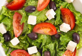 Background of Fresh Greek Salad with Olives Tomatos and Feta Cheese