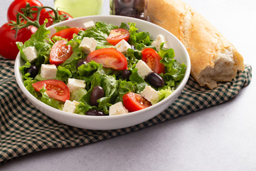 Greek Salad with Olives Tomatos and Feta Cheese on a Concrete Countertop