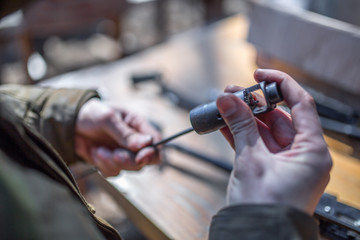 male person soldier cleans the weapon, disassemble, make maintenance of service weapon