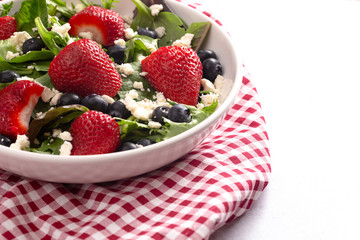 Bright Garden Salad with Fresh Fruit on a Red Gingham Tablecloth