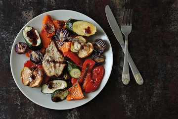 Warm salad with baked vegetables and fruits. Fitness food. Vegan diet
