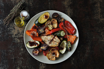 Warm salad with baked vegetables and fruits. Fitness food. Vegan diet