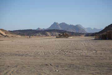 Fototapeta na wymiar Sunny noon in bedouin village with mountain view of desert near Hurghada, Egypt. Space for text