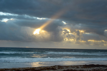 Sunrise in West Palm Beach, Florida with light coming through the clouds 