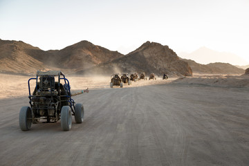 Extreme buggy races at sunset near the mountains and a Bedouin village in the desert near Hurghada....