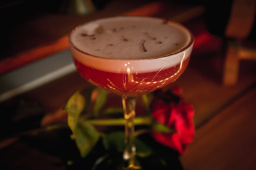 Clover club classy cocktail, with rose next to it