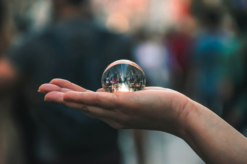 lensball on hand in the streets of the city.