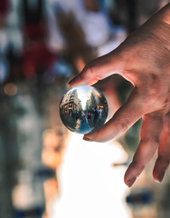 Fototapeta premium lensball on hand in the streets of the city.