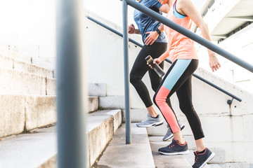 Hispanic Couple Running or Jogging Together Outdoors.