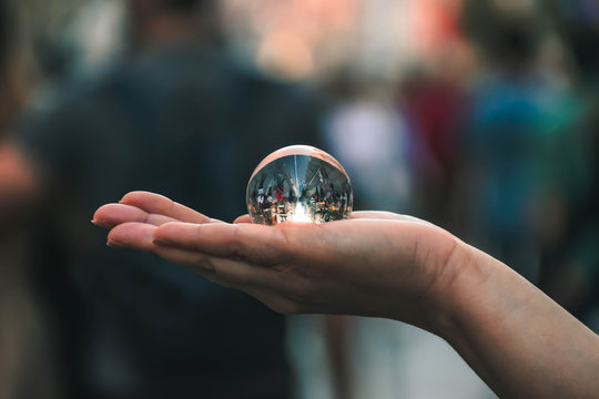 lensball on hand in the streets of the city.