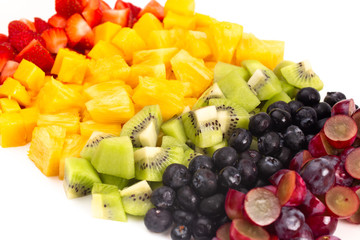 Lines of Rainbow Colored Fruit Isolated on White Background