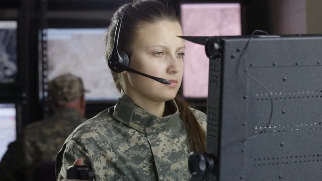 Female miltary drone operator on computer