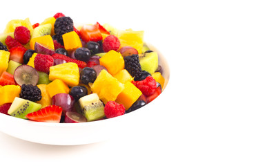 Bowl of Rainbow Colored Fruit Salad Isolated on a White Background